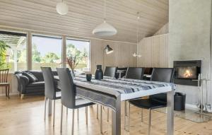 ジルレジェにあるAwesome Home In Gilleleje With Wifiのダイニングルーム(テーブル、椅子、暖炉付)