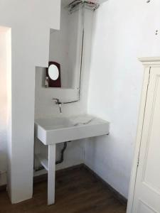 a bathroom with a white sink and a mirror at Spacious ground floor apartment in town centre in Hendaye