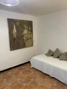 a room with two beds and a painting on the wall at Spacious ground floor apartment in town centre in Hendaye +20 photos