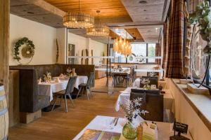 a restaurant with tables and chairs in a room at Appartements am Römerweg in Oberndorf in Tirol