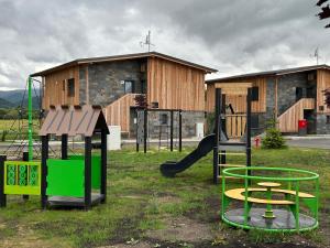a playground with a slide and a swing set at Apartmán C1 - Slovenský Raj in Hrabušice