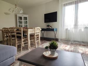 a living room with a table and a dining room at A Casa di Kate in Borno