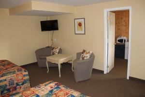 a hotel room with a bed and a chair and a table at Spring Lake Resort in Dwight