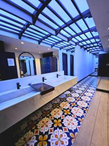 a bathroom with two sinks and a floral tile floor at La Casita Hua-Hin By 95 Group in Hua Hin