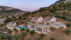 an aerial view of a house with a mountain at Doceo Refined Living in Nafplio
