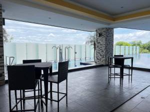 a dining room with a table and chairs on a balcony at G Home 1 - Ipoh City Center Majestic 2R2B in Ipoh