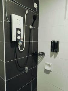 a shower in a bathroom with a phone on the wall at G Home 1 - Ipoh City Center Majestic 2R2B in Ipoh