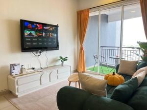 a living room with a couch and a flat screen tv at G Home 1 - Ipoh City Center Majestic 2R2B in Ipoh