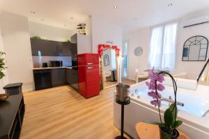 a kitchen and living room with a red refrigerator at Riviera Bliss in Nice