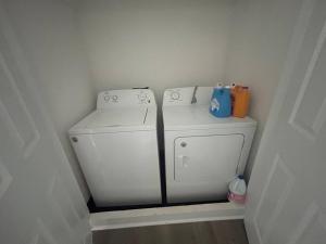 a white washer and dryer in a small room at Rome home close to tennis courts in Rome +12 photos