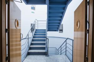 a stairway in a building with blue stairs at Alda Egues Rooms in Gorraiz