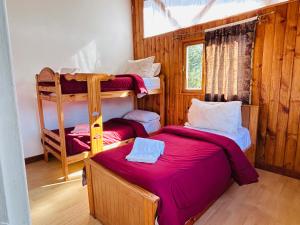 a room with two bunk beds and a window at Cabañas Quijote in Lago Puelo +23 photos