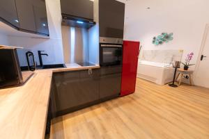 a kitchen with a red and black counter top at Riviera Bliss in Nice