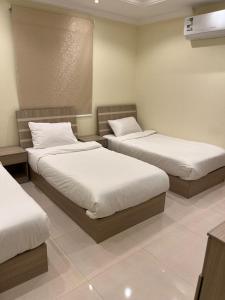 Postel nebo postele na pokoji v ubytování Al tawfeeg hotel - Al Azizyah