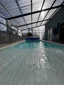 a swimming pool with water in a building at Cabañas Quijote in Lago Puelo