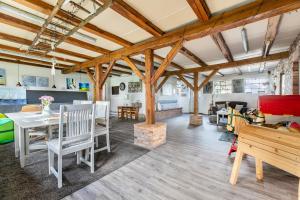 a living room with wooden ceilings and a table and chairs at Ferienwohnung Hof Krakebüll in Humptrup