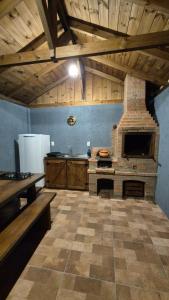 a large kitchen with a brick oven in a room at Pousada Recanto das Araucárias in Urubici +59 photos