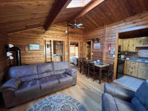 a living room with a couch and a table at Cabin 20 in Almont