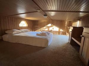 a bedroom with a bed with towels on it at Cabin 61 in Almont