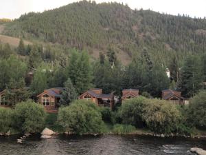 a group of houses on the side of a river at Cabin 61 in Almont