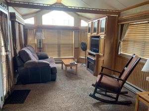 a living room with a couch and a chair at Cabin 63 in Almont