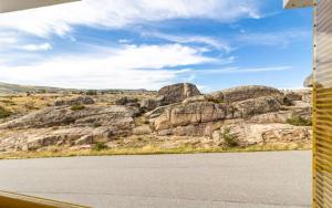 a view of a mountain with rocks and a road at Estrela Prime Stays in Penhas da Saúde