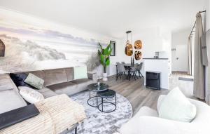 a living room with a couch and a fireplace at 2 Bedroom Lovely Home In Voorthuizen in Voorthuizen