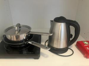 a tea pot and kettle on top of a stove at Krogsgaarden B&B in Nibe