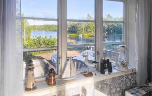 a window sill with a sink and a view of the water at Nice Home In Figeholm in Figeholm