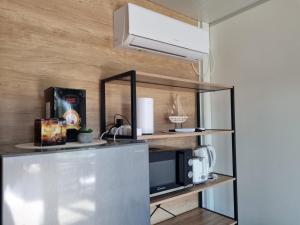 a kitchen with a counter top with a microwave at Mobile Home Elica, Pirovac in Pirovac