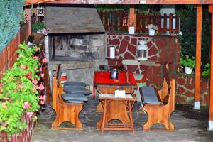 a patio with chairs and a table and a table and chairs at House By The River in Teteven