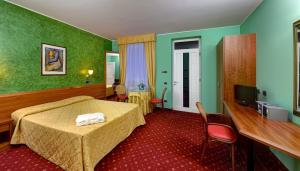 MontodineにあるHotel Motel Sportingのベッドとテレビが備わるホテルルームです。