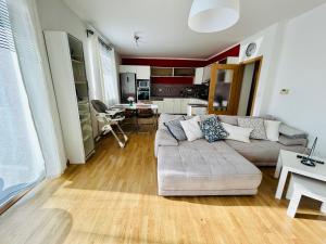 a living room with a couch and a table at Apartmán Mia in Jihlava