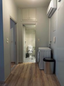 an empty bathroom with a toilet and a hallway at Ikia Mia Centrale in Rethymno Town +8 photos