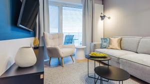 a living room with a couch and a table at Apartamenty Tukan- Polanki Aqua - Holiday City in Kołobrzeg