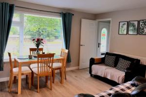 a living room with a table and chairs and a couch at Lough View in Belcoo