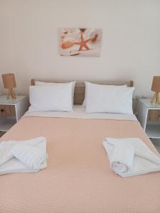 a bedroom with a bed with two towels on it at Agrilia in Lefkada