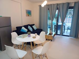 a living room with a table and chairs and a couch at Agrilia in Lefkada