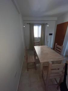 a dining room with a wooden table and chairs at Dpto en av mate de luna a estrenar in Villa Luján +2 photos