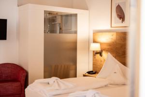 Postel nebo postele na pokoji v ubytování Parkhotel Tirolerhof