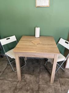 une table en bois avec deux chaises dans une chambre dans l'établissement Cocoun, à Cambrai 10 autres photos