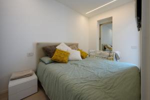 a bedroom with a bed with pillows on it at Appartamento Garibaldi in Morbegno