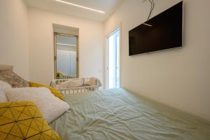 a living room with a couch and a flat screen tv at Appartamento Garibaldi in Morbegno