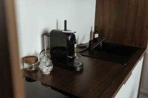 a coffee maker sitting on a wooden counter top at Insolite aventure exotique in Uzerche