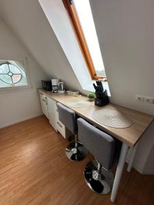 a kitchen with a table and chairs in a attic at Q2 Apartment Hannover Döhren mit Ausblick in Hannover +14 photos