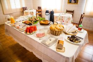 a table with many plates of food on it at Hotel Santa Catarina in Três Lagoas