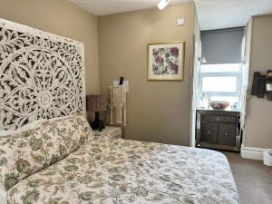 a bedroom with a large bed and a window at The Boho - 4 min walk to beach & town in Bournemouth
