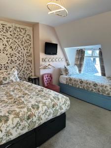 a bedroom with two beds and a window at The Boho - 4 min walk to beach & town in Bournemouth