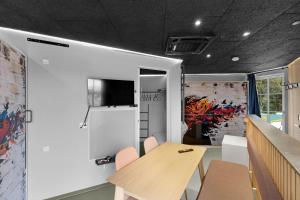 a conference room with a table and a tv on a wall at Fun Art - Art And Family Activities In The Holiday Apartment in Pandrup +13 photos