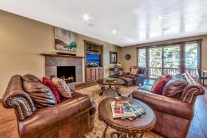 a living room with leather furniture and a fireplace at Lv12 luxury villa with hot tub, close to skiing in Glenbrook